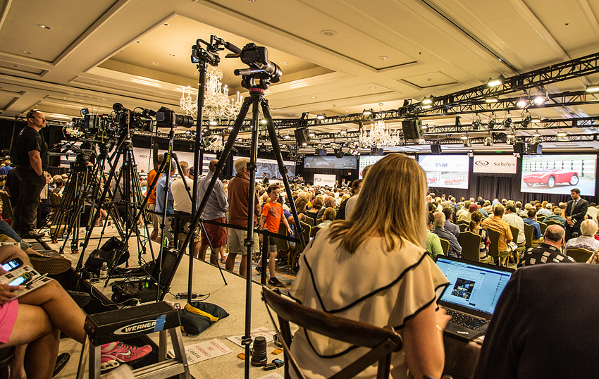Journalists and video cameras await the next big-ticket item.